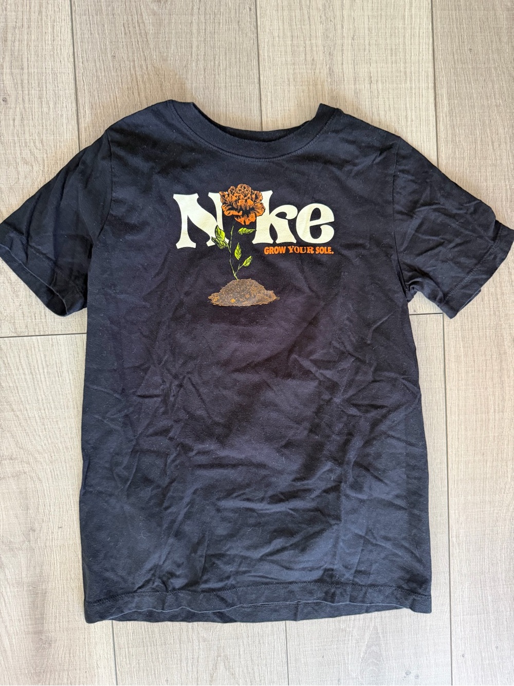 Nike Black Graphic Tee with Orange Flower and Cream Logo